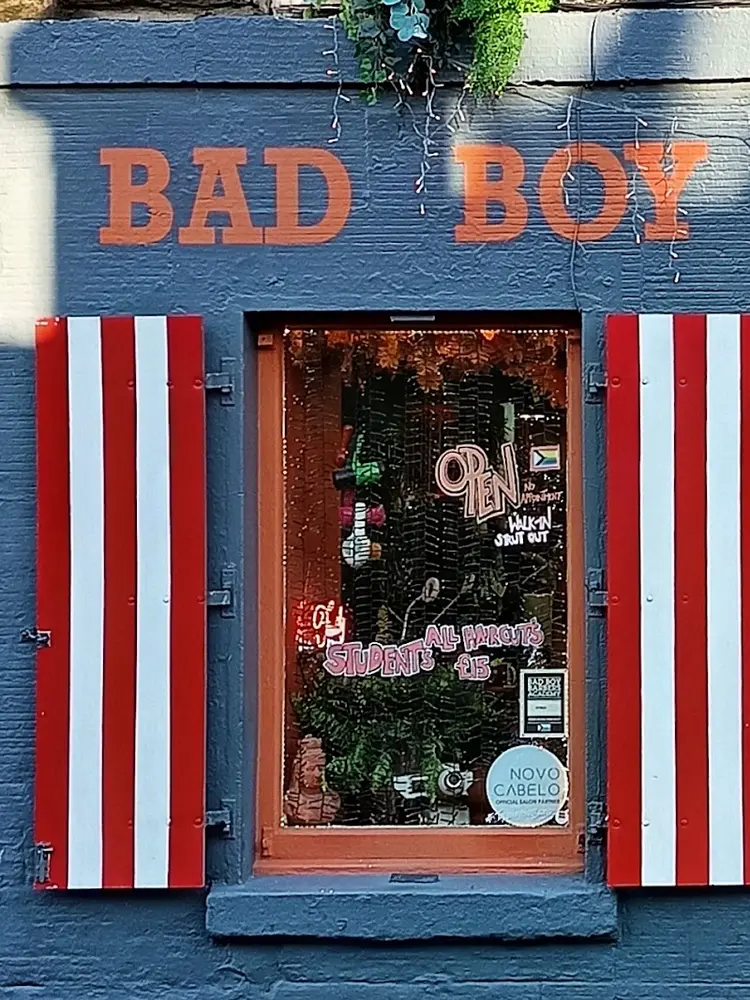Red and white striped shutters and hand-painted BAD BOY sign at the Candlemaker Row shopfront